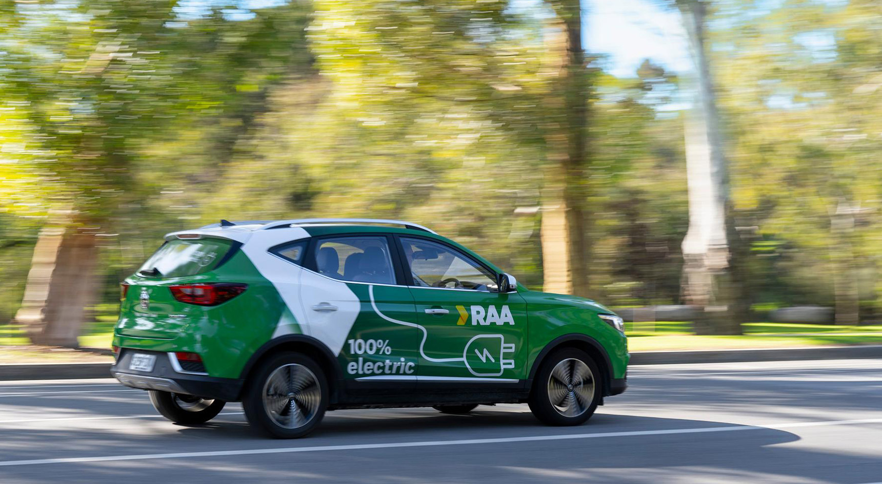 Green car travelling fast with RAA branding