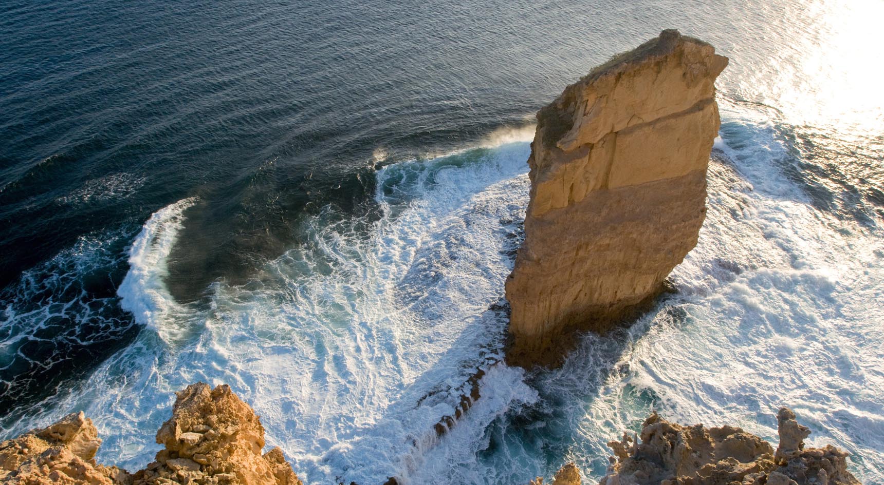 The cliffs and Cummings Monument, with waves crashing against the rocks.