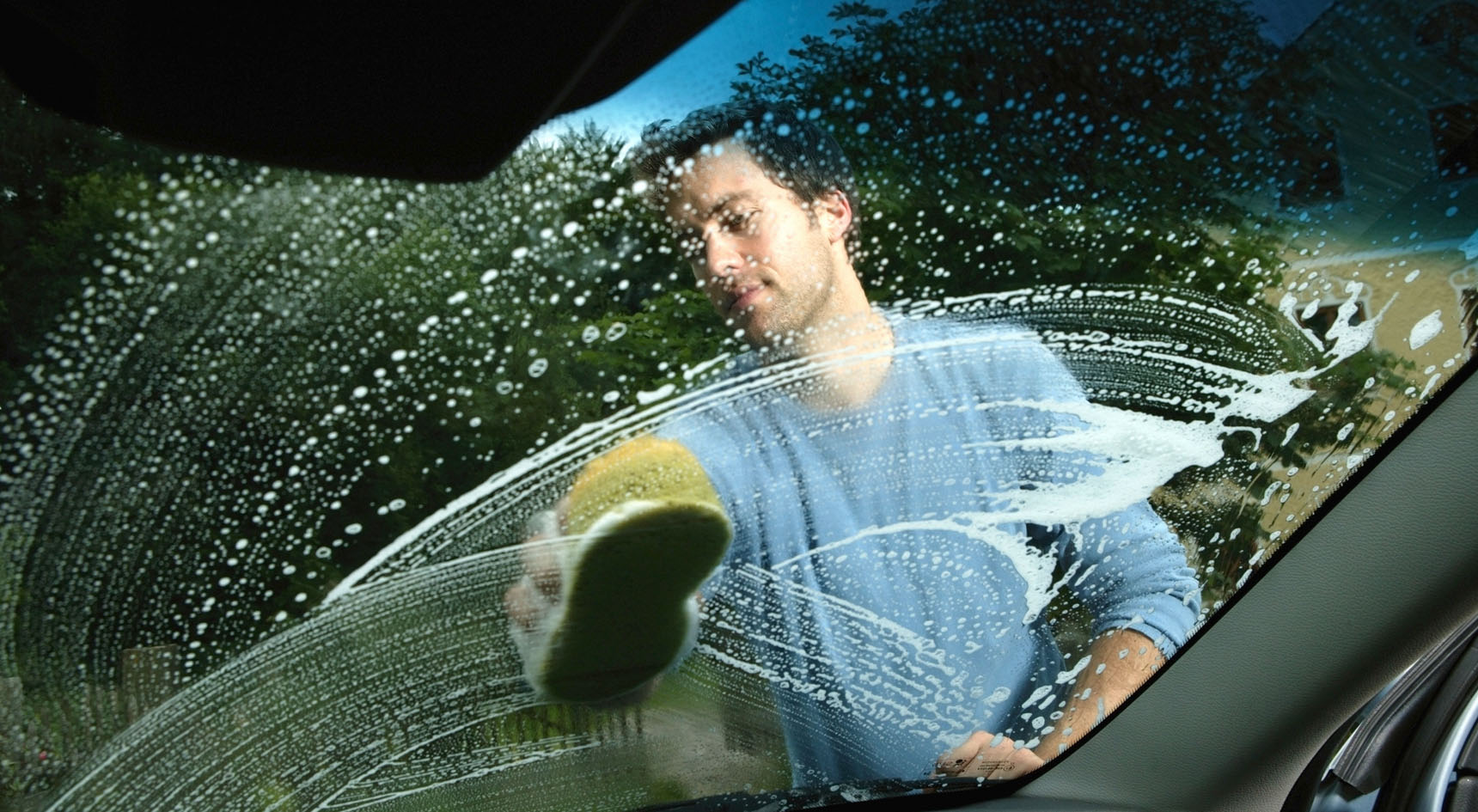 A man washing his windscreen