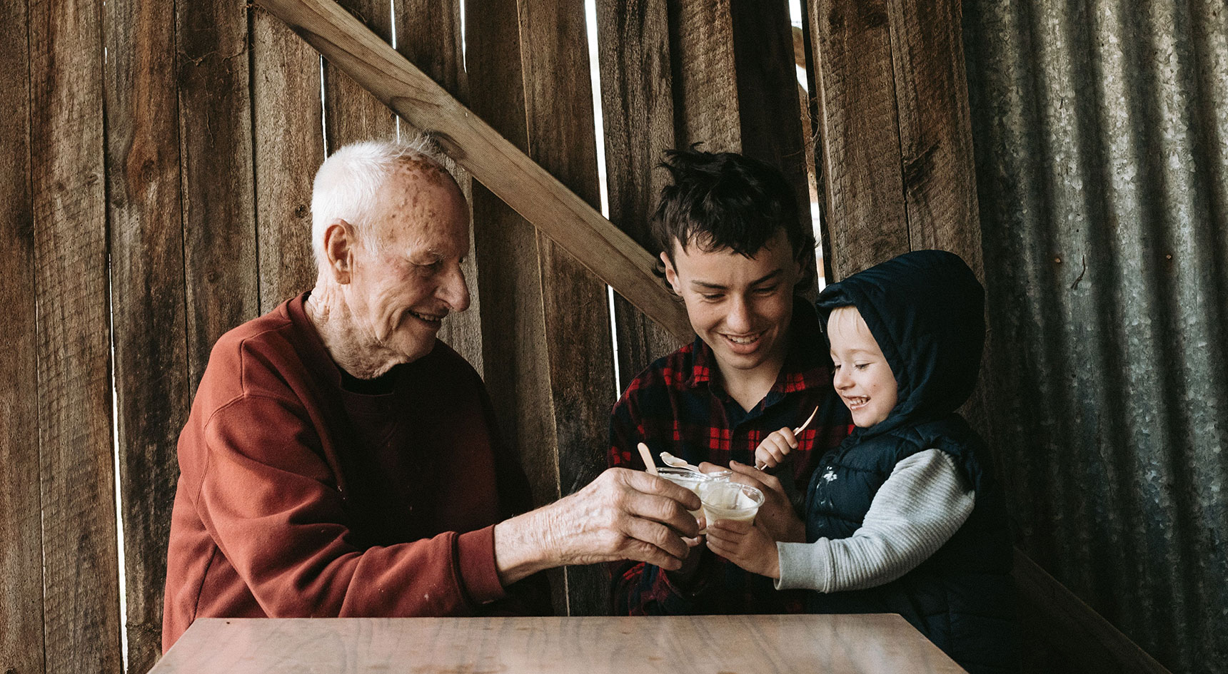 Three generational family eating honey icecream