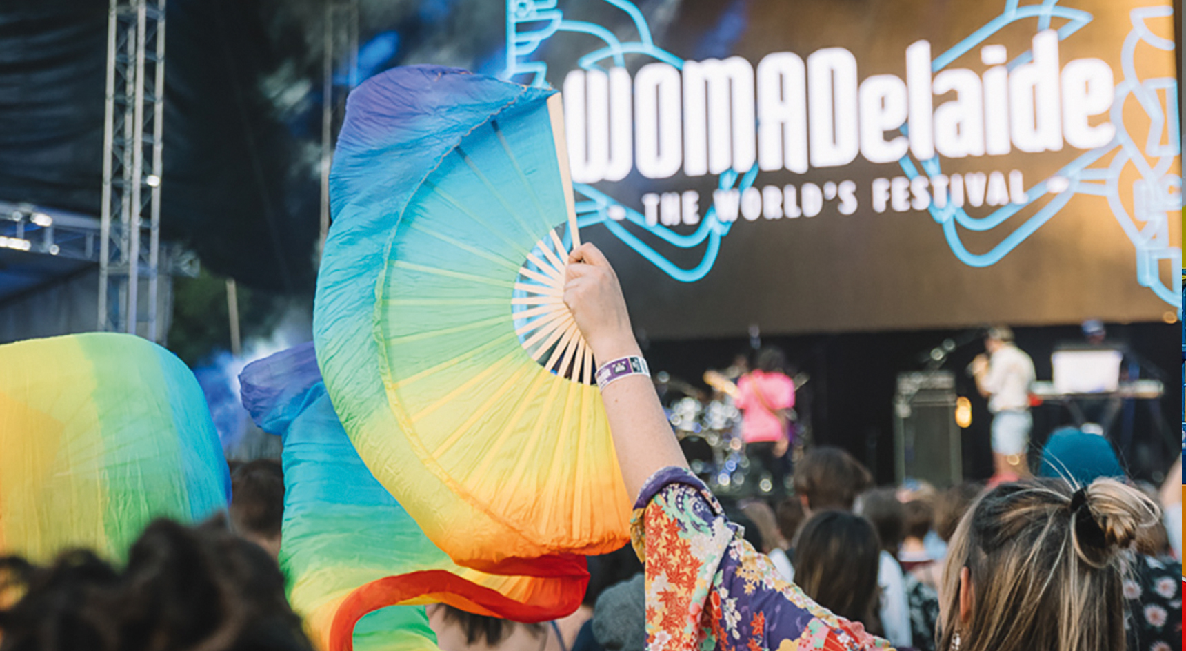 Festivalgoer waves colourful fan at WOMADelaide.