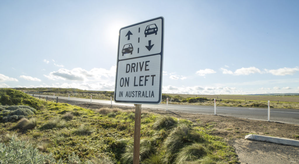 Sign near road reminding motorists that Australians drive on the left.