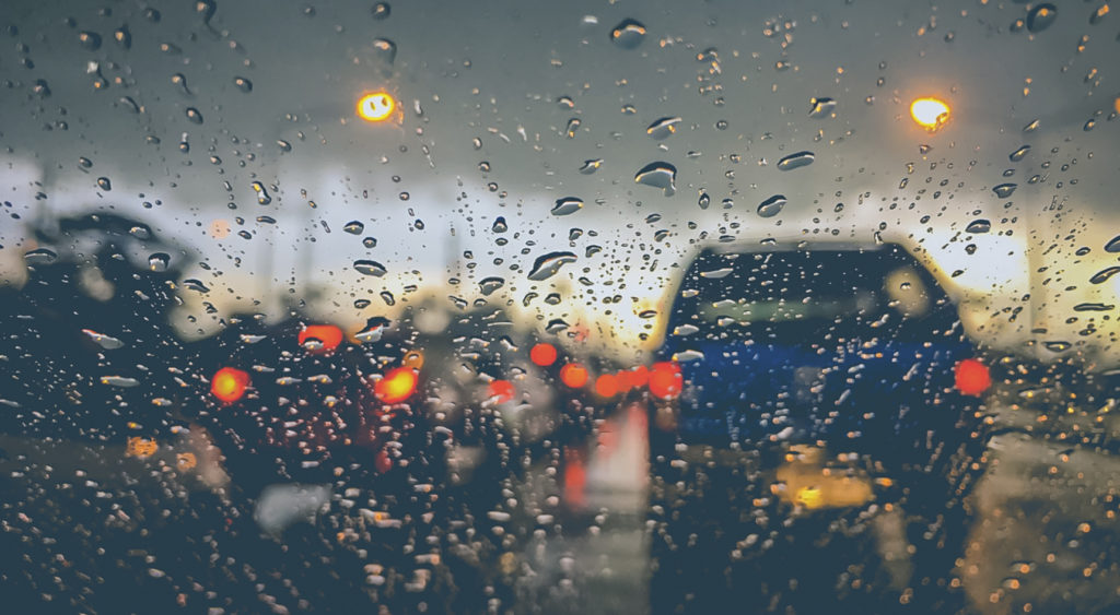 Car traffic seen through a wet window.