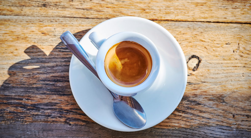 A cup of espresso on a wooden table. 