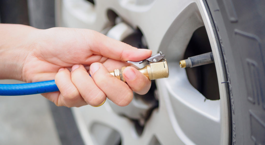 Person pumping up tyre.