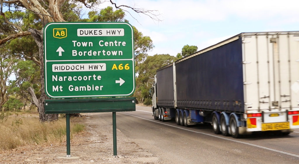 Image of a truck driving along the Dukes Hwy and passing sign for Riddoch and Dukes Highway.