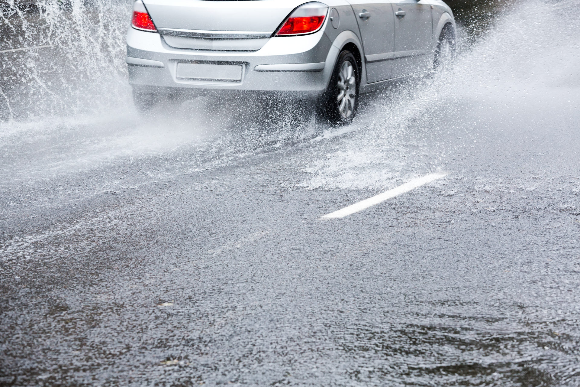 Drivers should reduce their speed when passing through a puddle. Image: Getty 