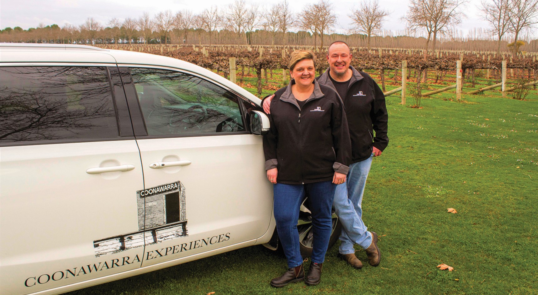 Simon and Kerry Meares stand in a vineyard in the Coonawarra beside their car. Image: Jamie McDonald