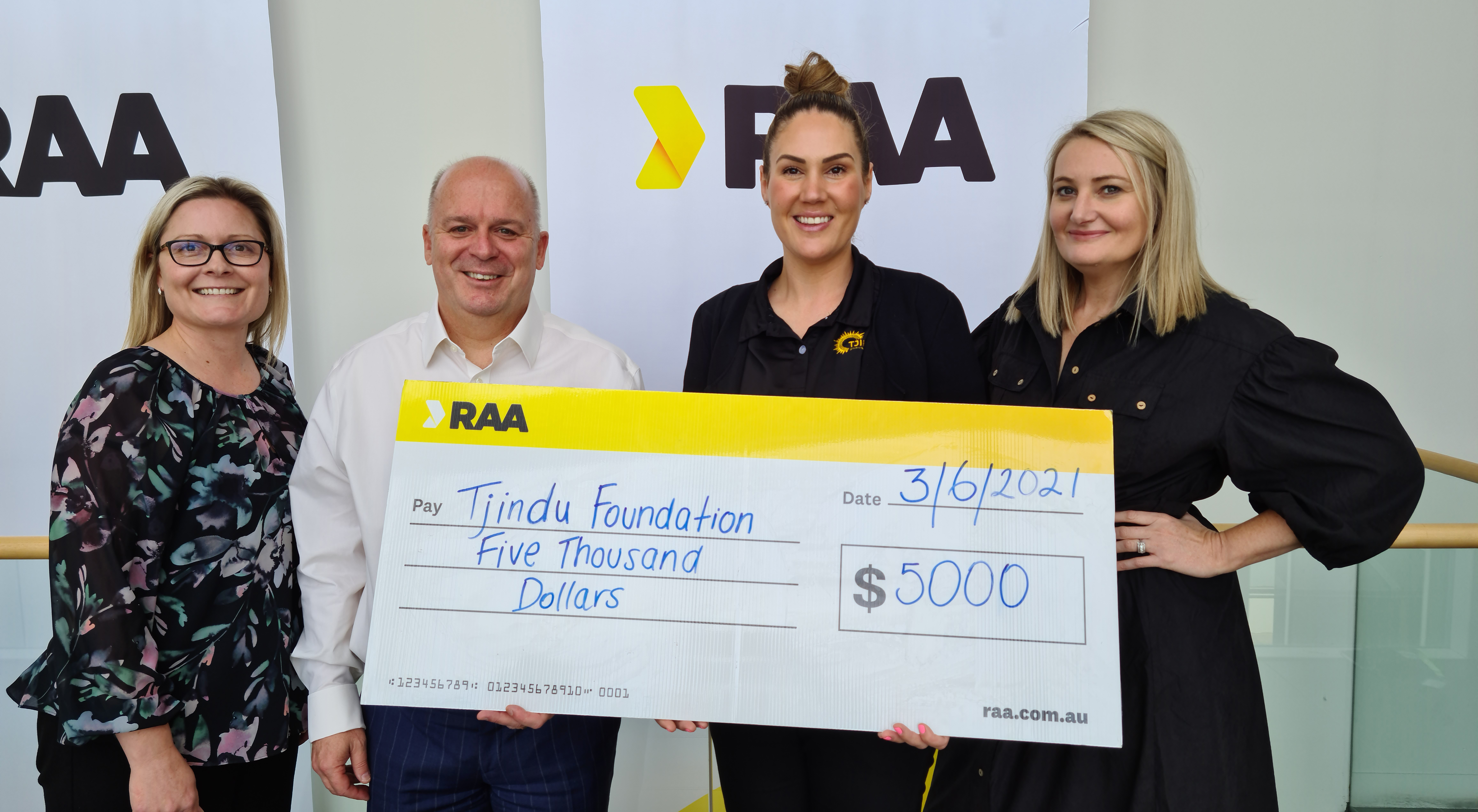 RAA's Belinda Vivian, Ian Stone (left) and Emily Perry (right) present Kellie Graves the Grassroots Giving Grant.