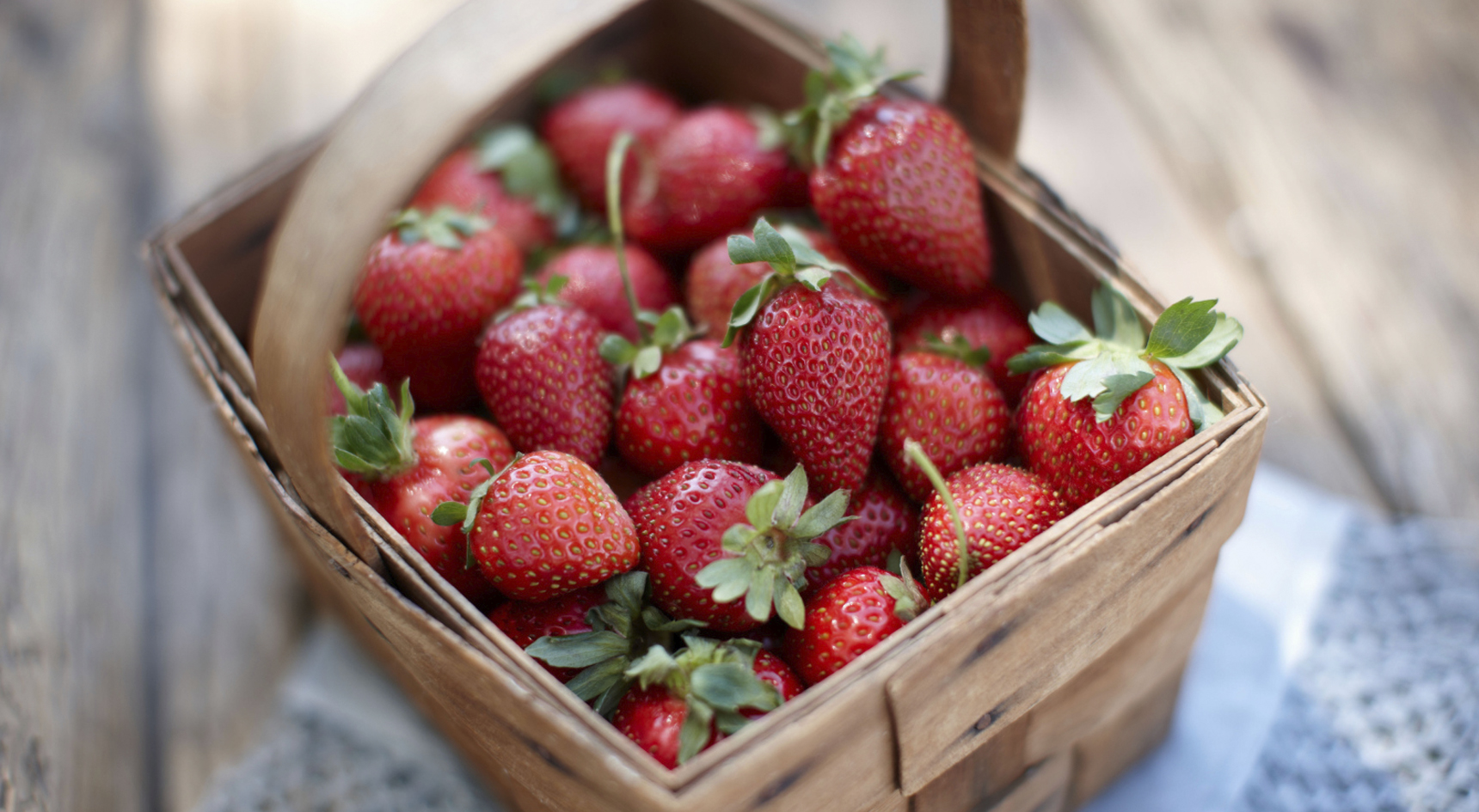 A basket full of juicy red strawberries.