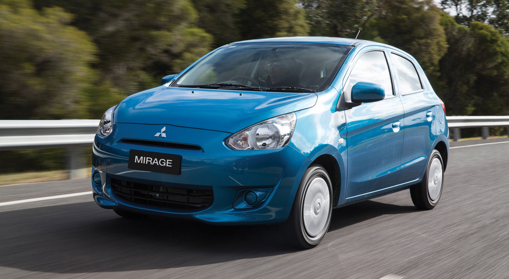 A blue Mitsubishi Mirage on the road.