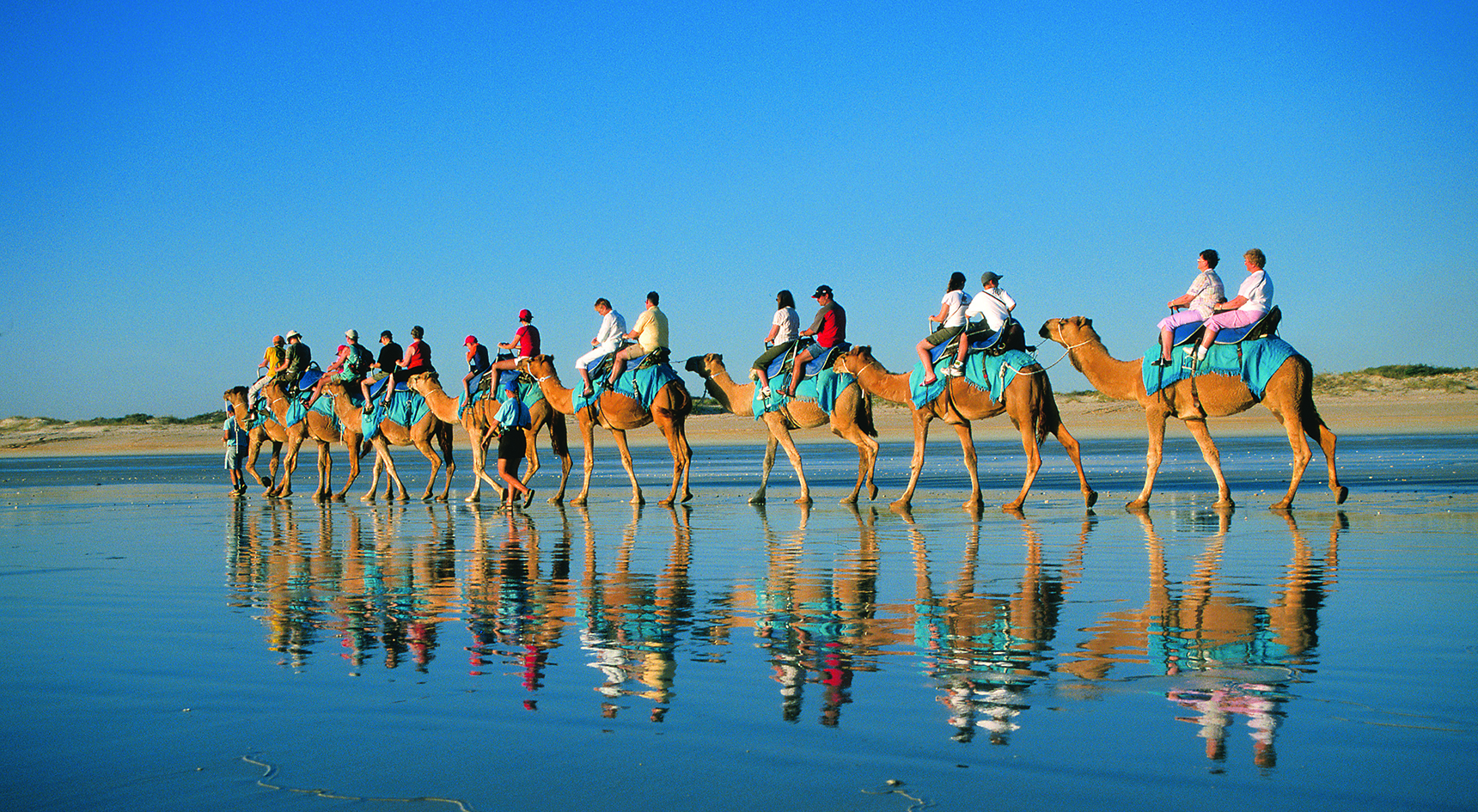 People riding camels at Broome's Cable Beach in WA.