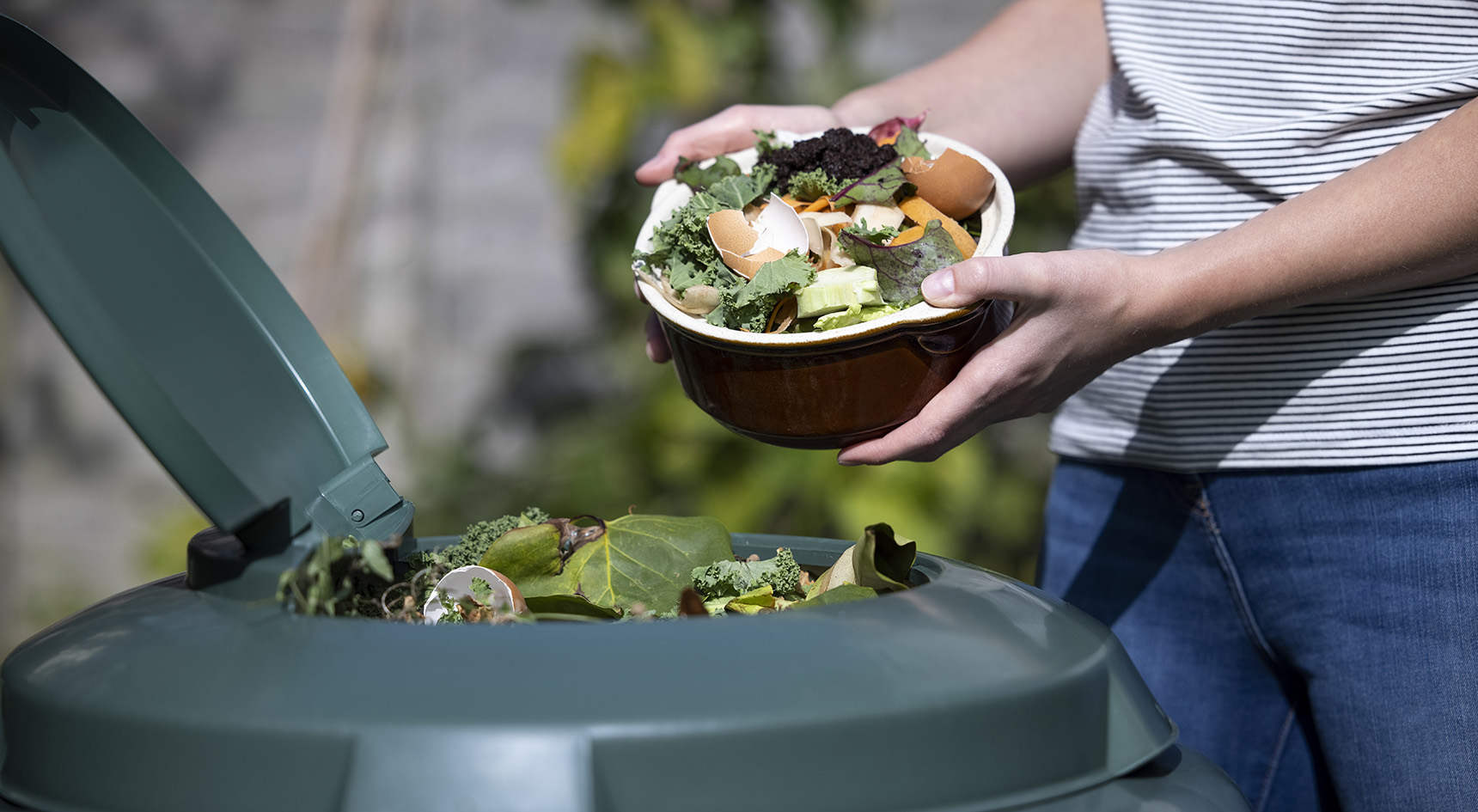 Compost bin and bowl filled with kitchen scraps.