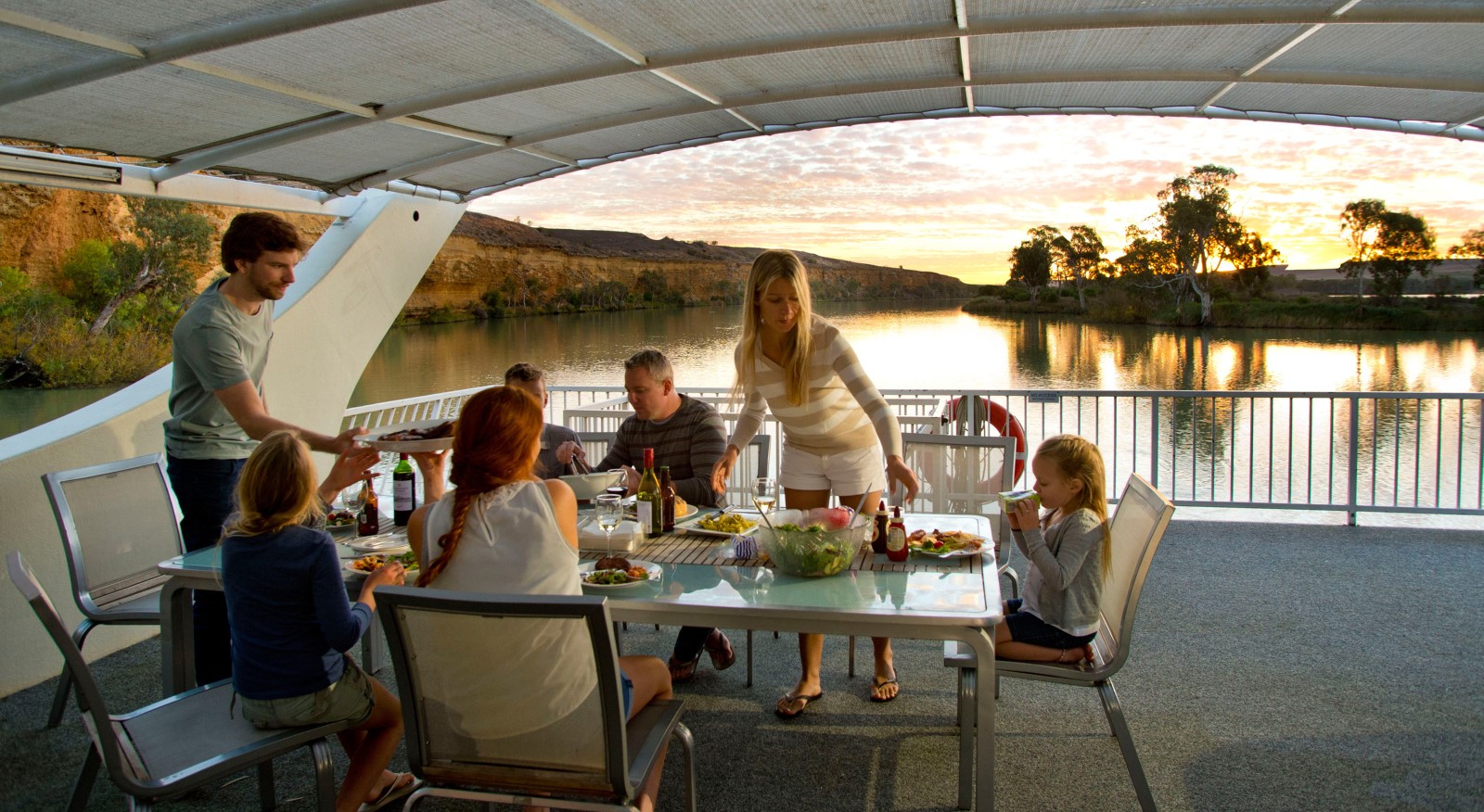 Family having meal on houseboat