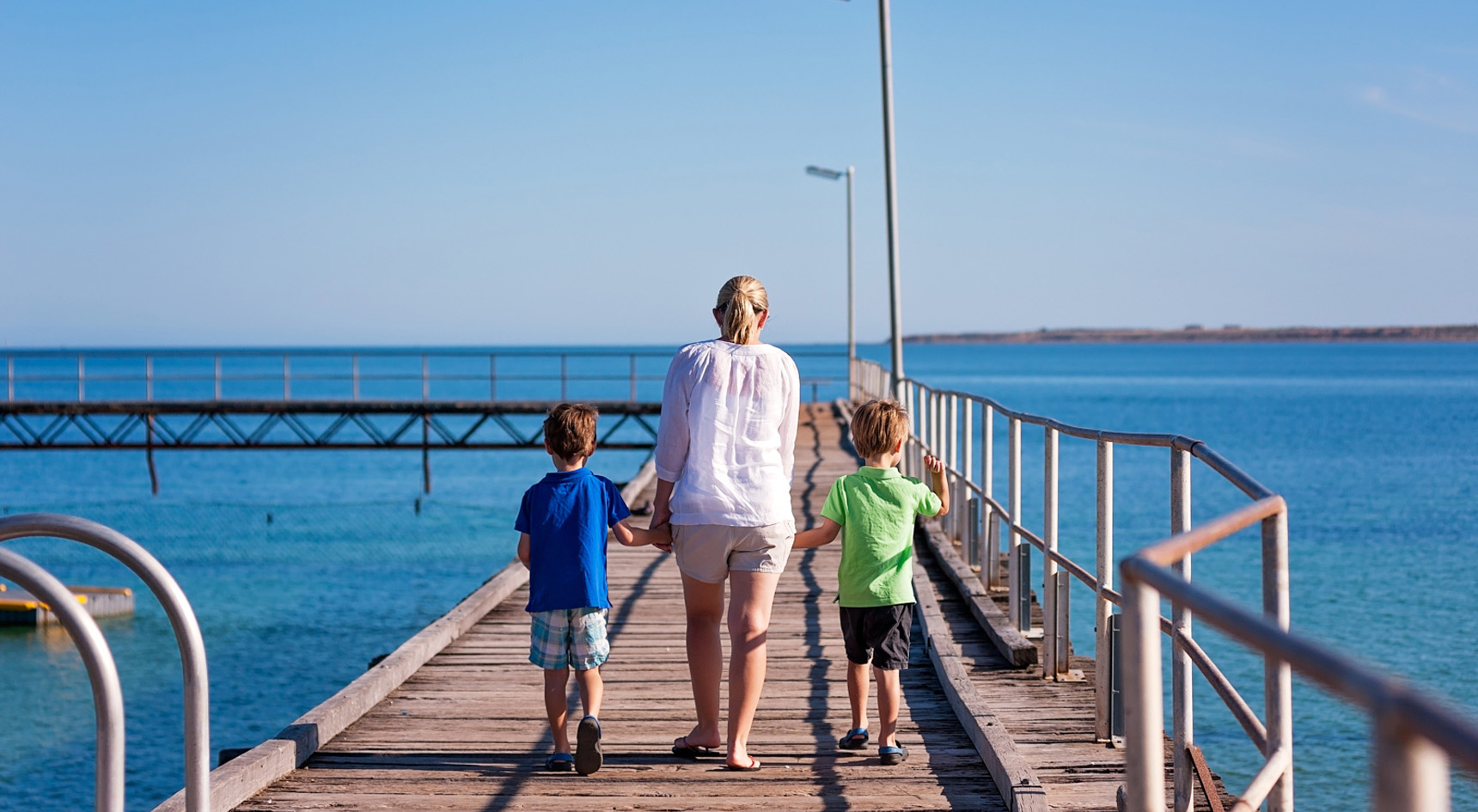 Mother and two sons walking on the Wallaroo Jetty. Image: SATC