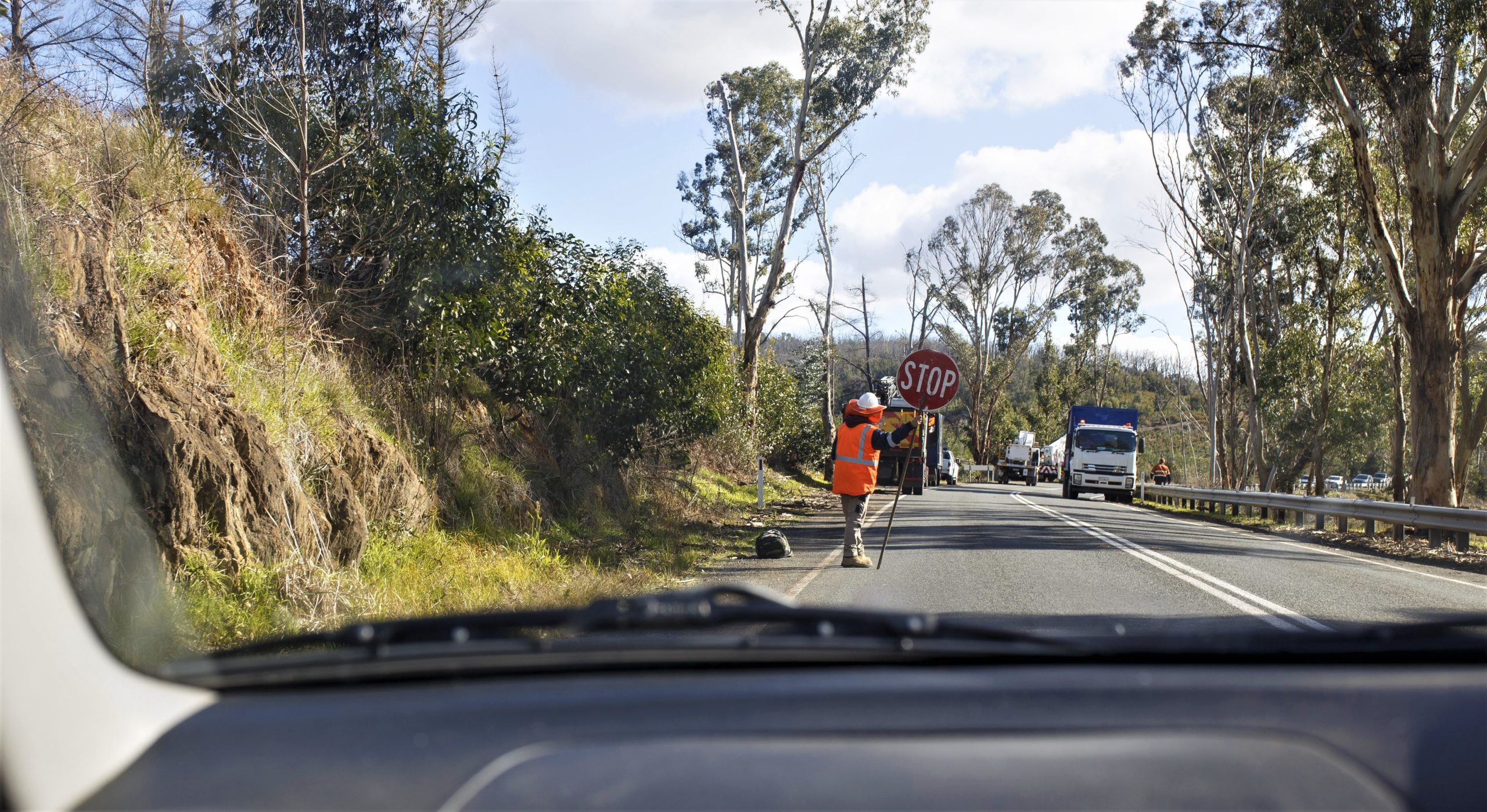 Road worker with stop sign at at roadworks