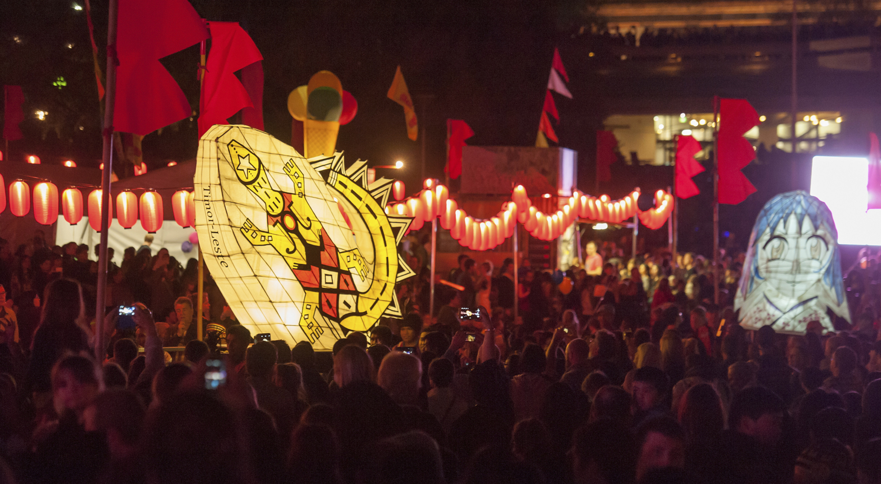 A image of moon lanterns among a crowd of people.