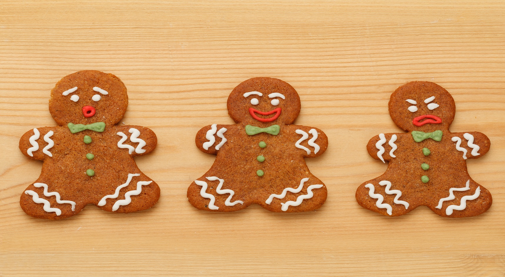 Three gingerbread men making funny faces.