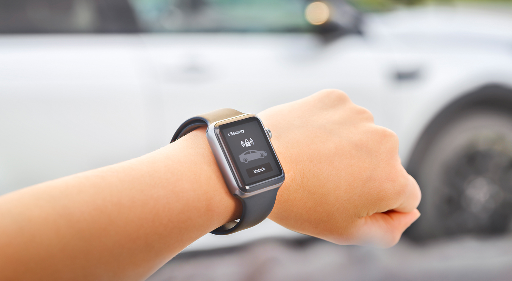 A person unlocking their car with a smartwatch