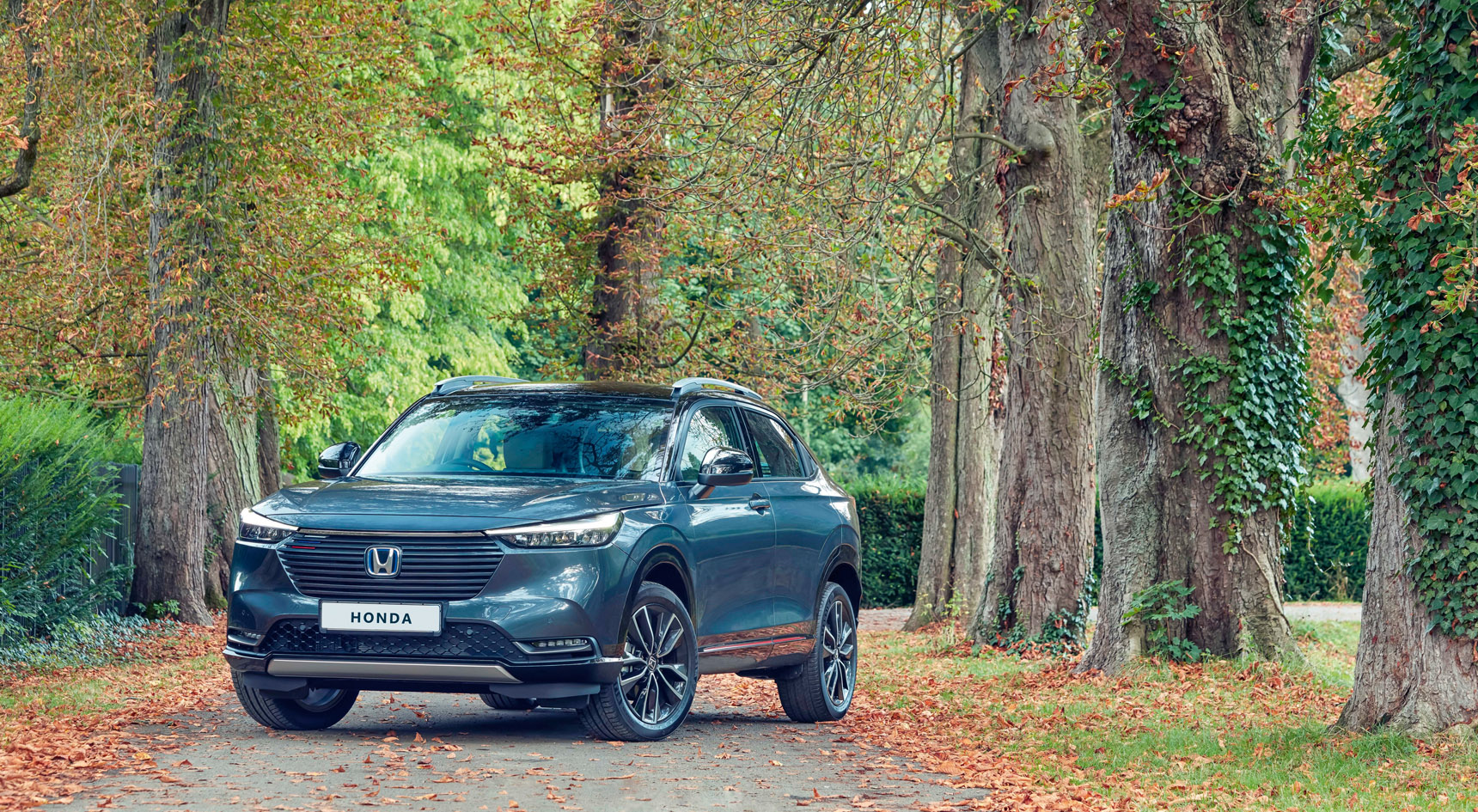 The Honda HR-V parked on the road among trees.