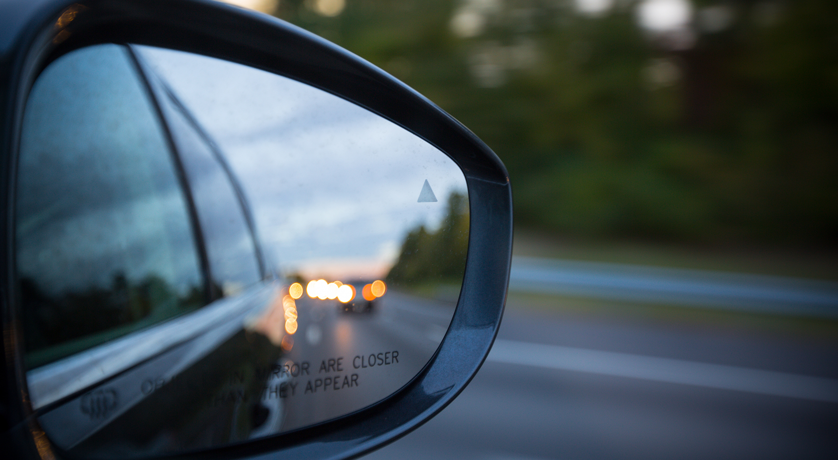 A mirror on a car with a blind spot.