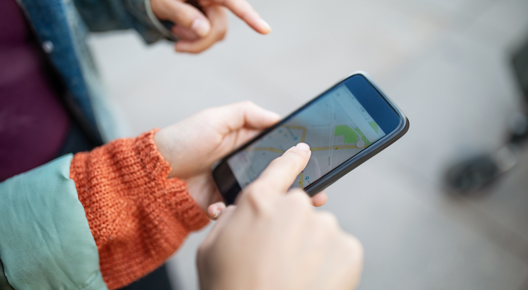 A person using their mobile phone map to find their car.