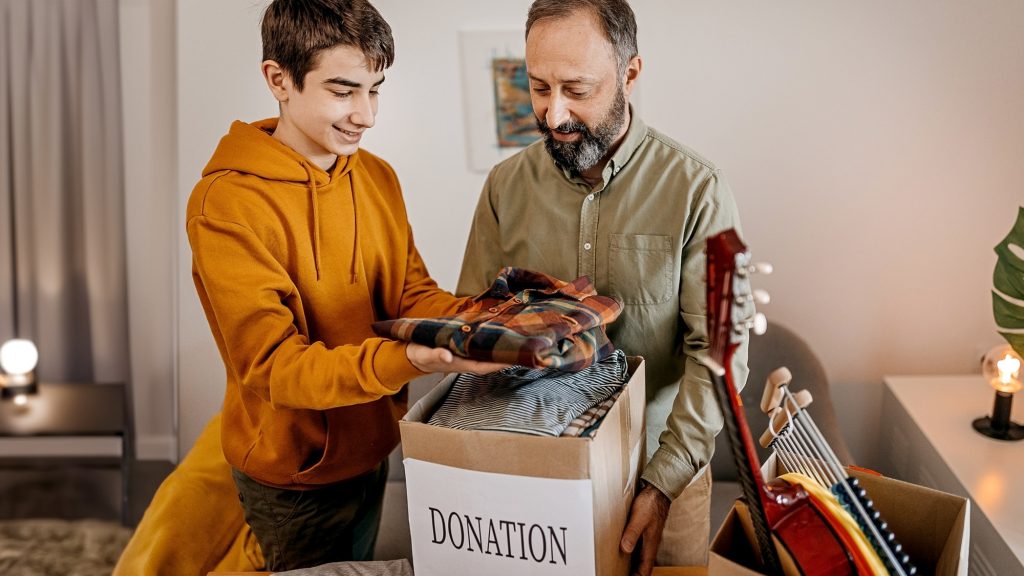 Son and father sorting items to donate