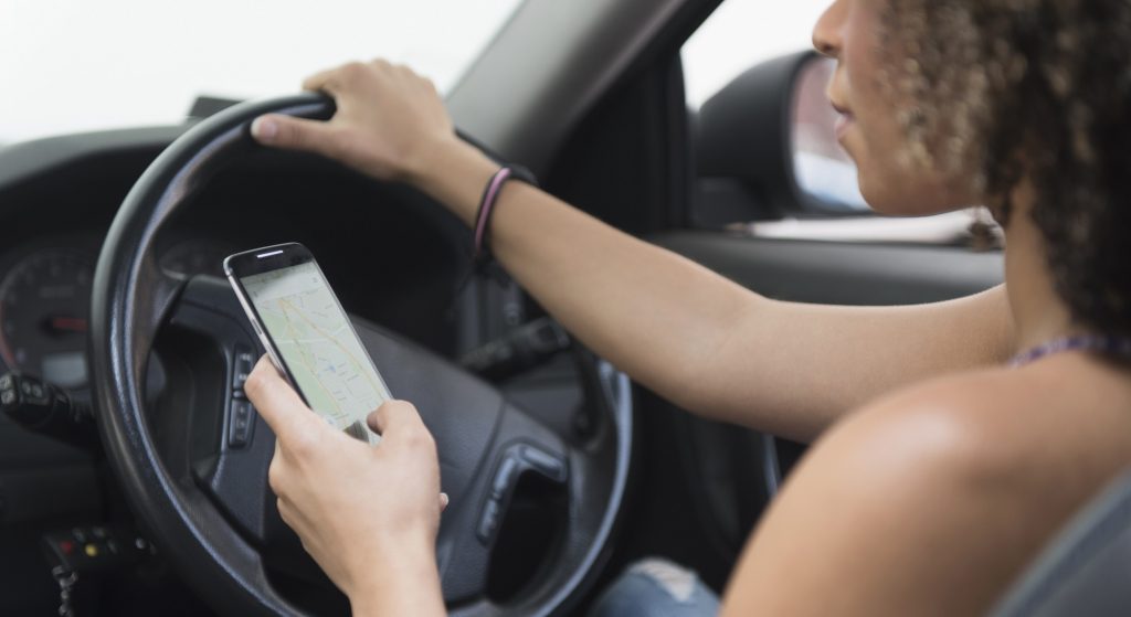 Driver uses mobile phone while driving.